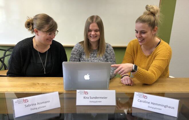Drei Frauen vom Dialog sitzen am Laptop
